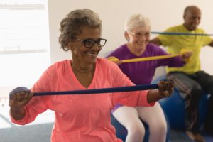 A group of seniors exercise with resistance bands, senior living marietta ga